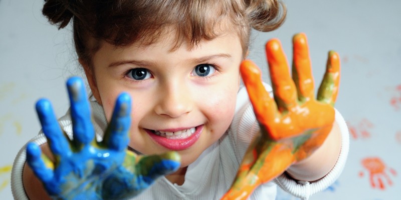 Little girl playing with colors