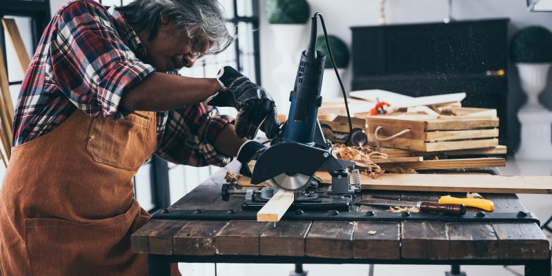 old carpenter man working in carpenter studio