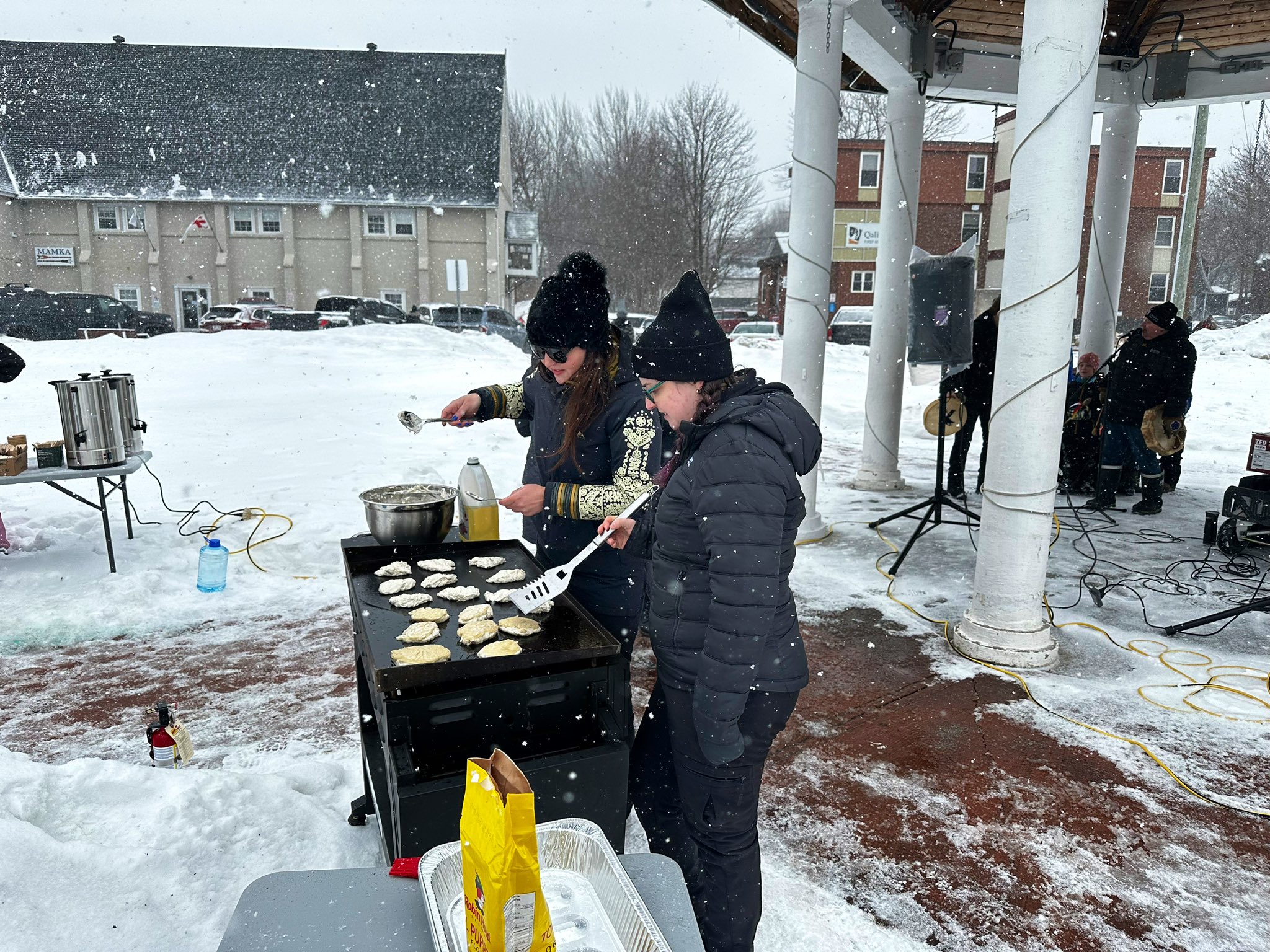 Chief Brake and Jasmine, Mental Wellness Outreach Officer cooking Bannock