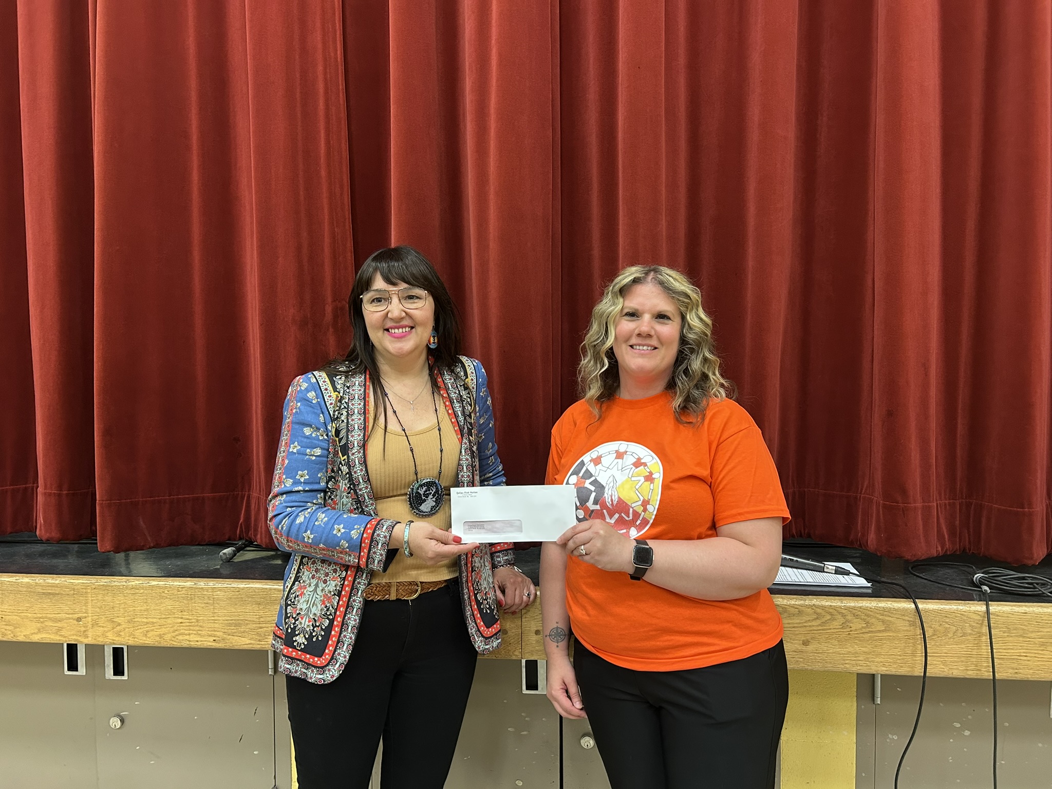 Chief Jenny presenting a $500 cheque to Ms. Neville for the school breakfast program.