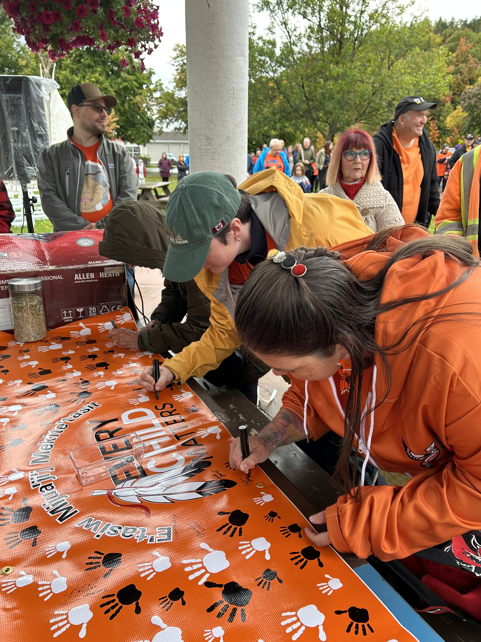 Community members signing the Every Child Matters banner 