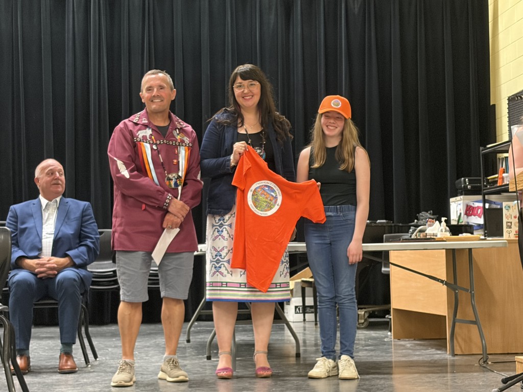 L-R: Corner Brook Ward Councillor Ernest Green and Chief Jenny Brake presenting the award to Lydia Dyer